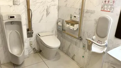 a bathroom with a toilet and a urinal at Toyoko Inn Tokyo Nihombashi Hamacho Meijiza Mae in Tokyo