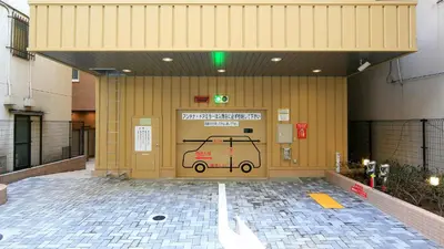 a building with a door with a car on it at Toyoko Inn Nihombashi Bakurocho in Tokyo