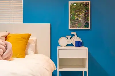 a bedroom with a bed and a table with a phone on it at Shinjuku ICE MOUNTAIN GUEST HOUSE in Tokyo