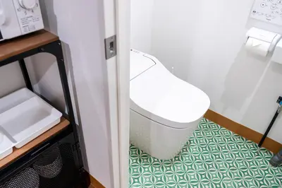 a white chair sitting on the floor in a room at Shinjuku ICE MOUNTAIN GUEST HOUSE in Tokyo
