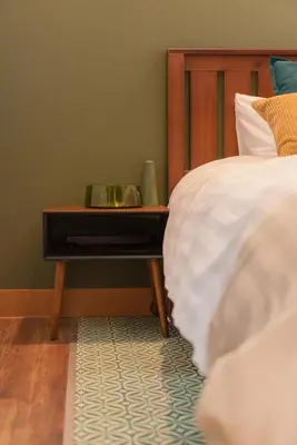a bed with a nightstand next to a bed with a bed sidx sidx sidx at Shinjuku ICE MOUNTAIN GUEST HOUSE in Tokyo