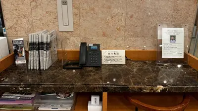 a counter with a phone on top of it at Toyoko Inn Tokyo Yamanote sen Otsuka eki Kita guchi No 2 in Tokyo