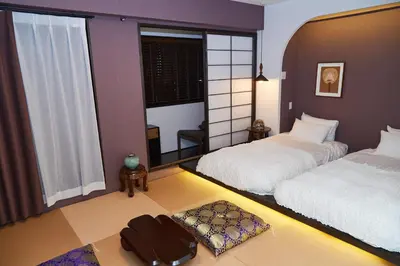 a bedroom with two beds and a large window at Asakusa New City Hotel in Tokyo