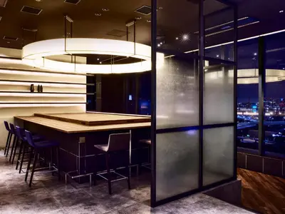 a bar in a restaurant with a view of the city at LOISIR HOTEL SHINAGAWA SEASIDE in Tokyo
