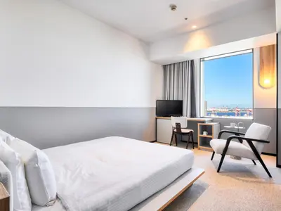 a bedroom with a bed and a desk and a television at LOISIR HOTEL SHINAGAWA SEASIDE in Tokyo