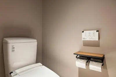 a bathroom with a toilet and two rolls of toilet paper at Hotel Asakusa KANNONURA in Tokyo