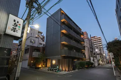 a tall black building on a city street at Hotel Asakusa KANNONURA in Tokyo