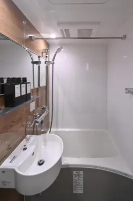 a bathroom with a white sink in a room at Stylewood Nishi-Shinjuku by Tranova in Tokyo