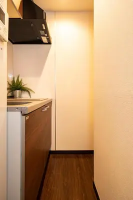 a small kitchen with a sink and a refrigerator at Apartment Sunbright in Tokyo