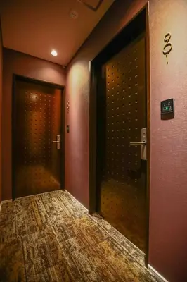 an empty hallway with two doors to a room at the Moto Hotel Asakusa in Tokyo