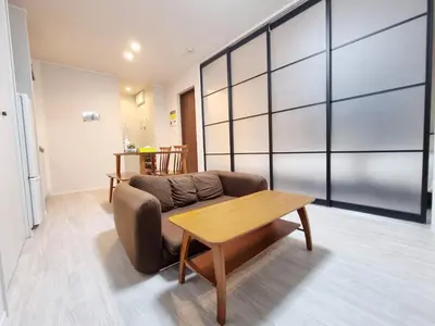 a living room with a couch and a table at PRISM Inn Kamata in Tokyo