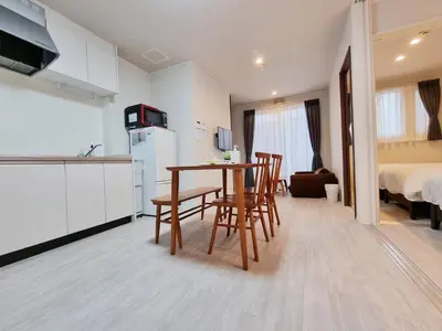 a kitchen and dining room with a table and chairs at PRISM Inn Kamata in Tokyo