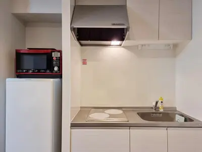 a small kitchen with a sink and a microwave at PRISM Inn Kamata in Tokyo
