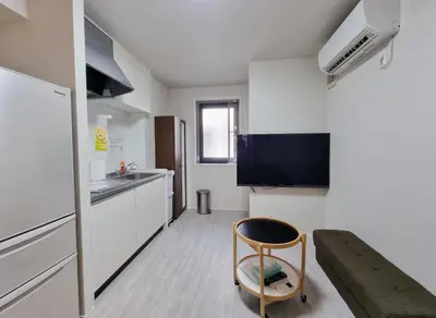 a small kitchen with a chair in a room at Lien \u897f\u65b0\u5bbf in Tokyo