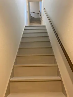 a stair case in a house with white stairs at Lien \u897f\u65b0\u5bbf in Tokyo