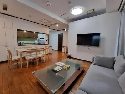 a living room with a couch and a table at PRISM COURT \u7dbe\u702c in Tokyo