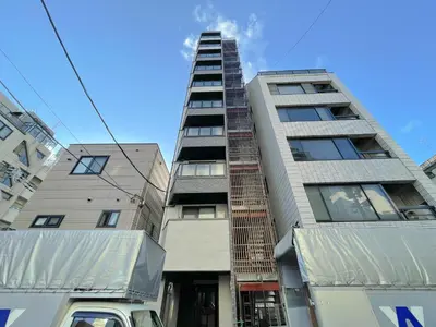 a tallartment building with a truck parked in front of it at Mr Kintaro Hotel Asakusa South in Tokyo