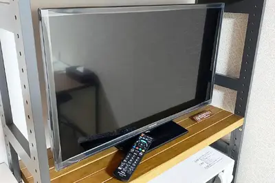 a tv with two remote controls sitting on a shelf at Mr Kintaro Hotel Asakusa South in Tokyo