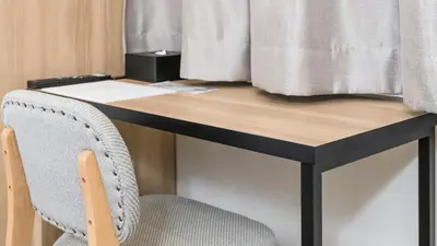 a desk with a chair next to a window at yksi SAUNA & STAY in Tokyo