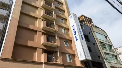 a building with a sign on the side of it at Toyoko Inn Tokyo Nihombashi Mitsukoshi Mae A4 in Tokyo