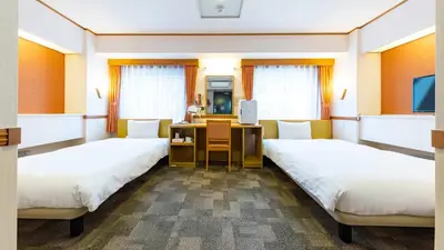 a hospital room with two beds and a desk at Toyoko Inn Kanda Akihabara in Tokyo