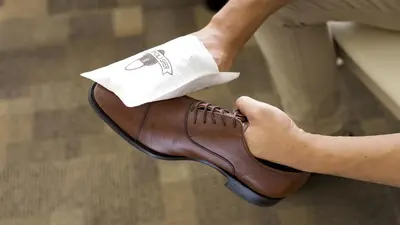 a person is holding their foot in a shoe at Toyoko Inn Kanda Akihabara in Tokyo