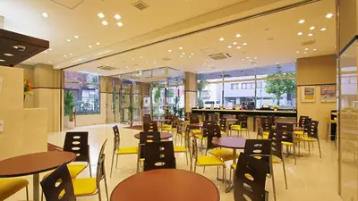 a restaurant with tables and chairs and a bar at Toyoko Inn Kanda Akihabara in Tokyo