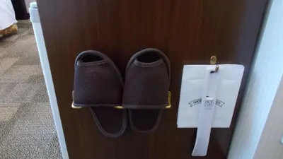 a pair of shoes and a knife on a door at Toyoko Inn Tokyo Ueno Tawaramachi eki in Tokyo