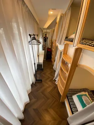 a hallway of a dorm room with white curtains at 54Journey \u6771\u4eac\u8d64\u5742\u30db\u30b9\u30c6\u30eb in Tokyo
