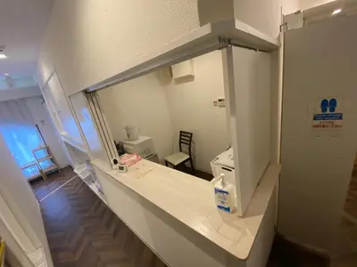 a hospital room with a large mirror on the wall at 54Journey \u6771\u4eac\u8d64\u5742\u30db\u30b9\u30c6\u30eb in Tokyo