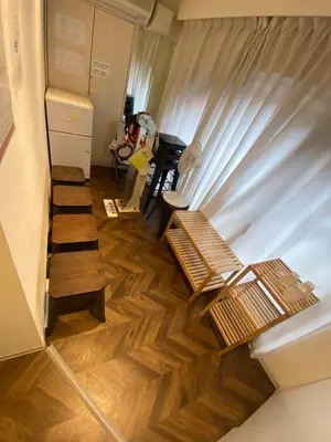 a living room with wooden floors and wooden benches at 54Journey \u6771\u4eac\u8d64\u5742\u30db\u30b9\u30c6\u30eb in Tokyo