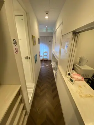 a hallway of a hospital with a room with a stairway at 54Journey \u6771\u4eac\u8d64\u5742\u30db\u30b9\u30c6\u30eb in Tokyo