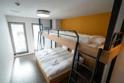 a room with two bunk beds with white sheets at COB HOTEL Asakusa in Tokyo