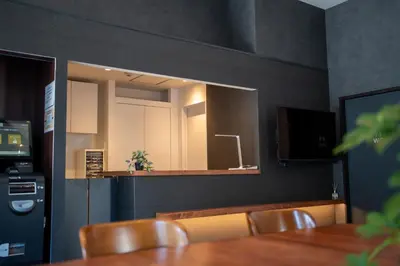 a dining room with a mirror and a table and chairs at COB HOTEL Asakusa in Tokyo