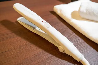 two white wii controllers sitting on a wooden table at COB HOTEL Asakusa in Tokyo