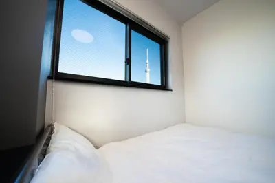 a bedroom with a bed and a window with a view at COB HOTEL Asakusa in Tokyo
