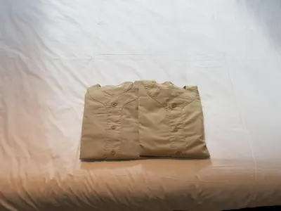 a jacket sitting on top of a bed at all day place shibuya in Tokyo