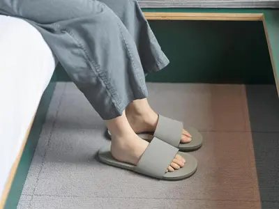 a person wearing sandals in front of a mirror at all day place shibuya in Tokyo