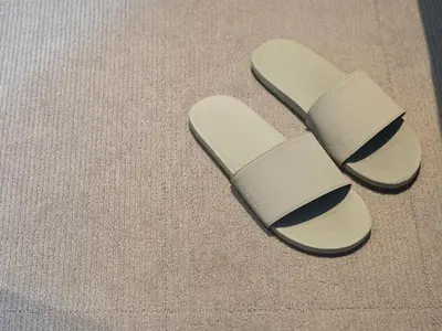 a pair of sandals sitting on the floor at all day place shibuya in Tokyo