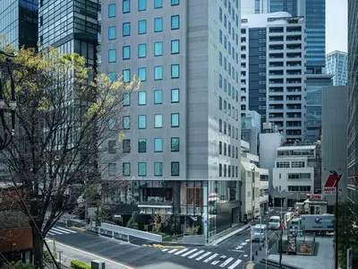 a view of a city street with a tall building at all day place shibuya in Tokyo