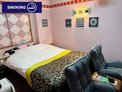 a hotel room with a bed and a chair at Restay lagoon in Tokyo