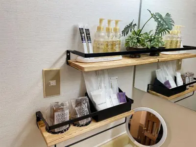 a shelf on a wall with bottles and a mirror at Restay lagoon in Tokyo
