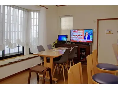 a living room with a dining table and a television at NYOZE House - Vacation STAY 84305v in Tokyo