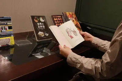 a person reading a book at a desk at BOOK HOTEL \u795e\u4fdd\u753a in Tokyo