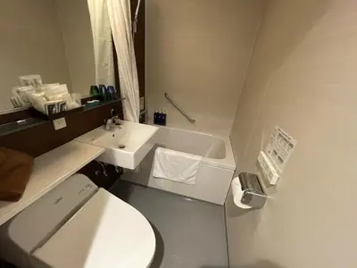 a bathroom with a white toilet and a sink at BOOK HOTEL \u795e\u4fdd\u753a in Tokyo