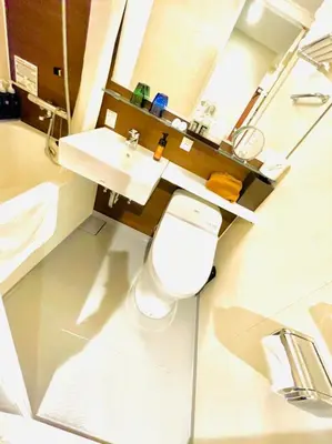 a bathroom with a white toilet and a sink at BOOK HOTEL \u795e\u4fdd\u753a in Tokyo