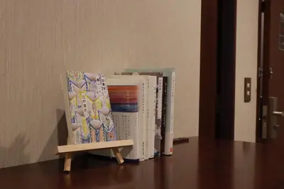 a chair sitting next to two books on a table at BOOK HOTEL \u795e\u4fdd\u753a in Tokyo