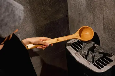 a person holding a wooden spoon in a trash can at BOOK HOTEL \u795e\u4fdd\u753a in Tokyo