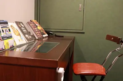 a desk with a red chair in a room at BOOK HOTEL \u795e\u4fdd\u753a in Tokyo