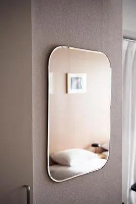 a mirror on a wall with a bed in a room at renovated in June 2025 apartment 3mins walk to station 1stop to Shinjuku 3stop to Shibuya in Tokyo